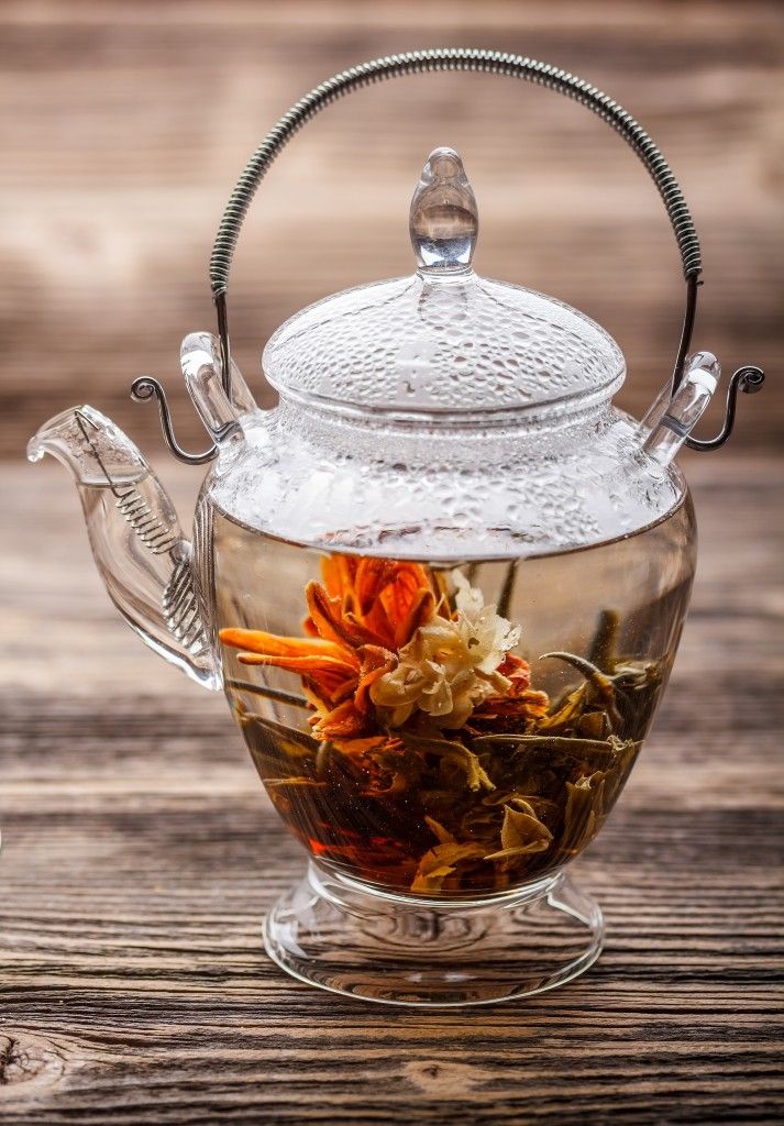 blooming _ flowering tea in a clear glass teapot